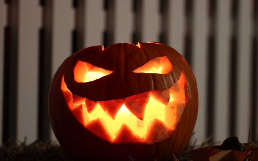 jackolantern in front of white fence- Halloween In Cape May